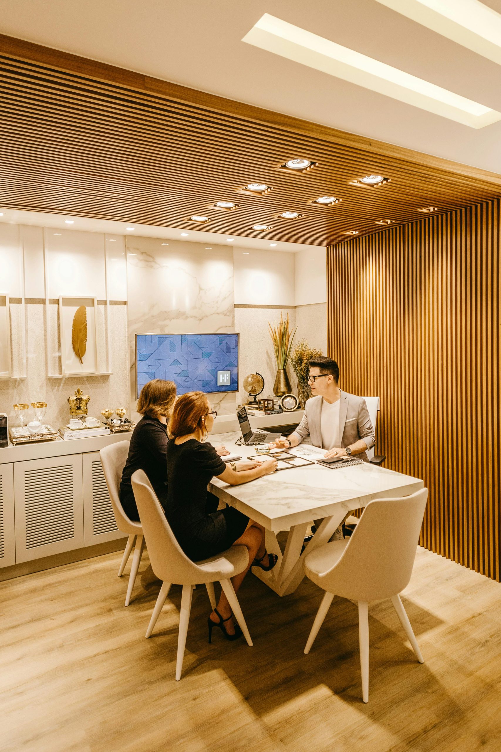 A diverse management team collaborating on architectural sketches and digital data for a large-scale infrastructure project.